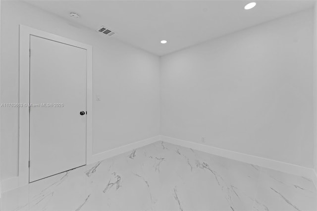 spare room with recessed lighting, baseboards, visible vents, and marble finish floor