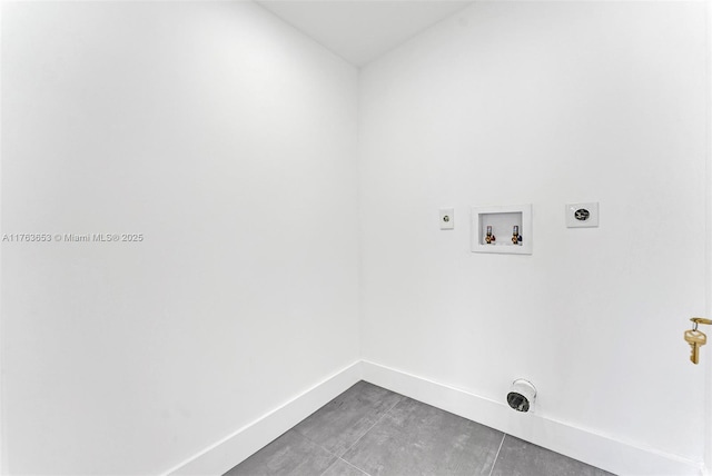 laundry area with laundry area, hookup for a washing machine, baseboards, and hookup for an electric dryer