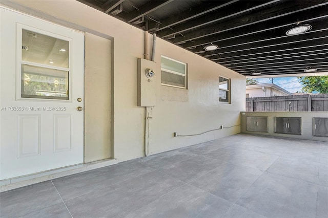 view of patio featuring fence