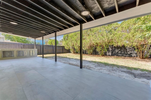 view of patio with area for grilling and a fenced backyard