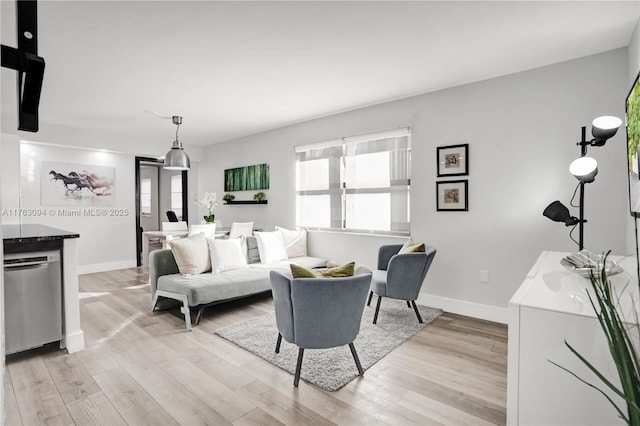 living room with light wood-type flooring and baseboards