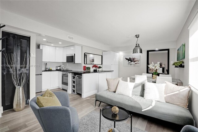 619 Euclid Ave Unit 1B, Miami Beach, FL 33139 - living room with light wood finished floors and recessed lighting