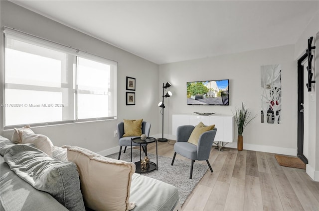 living area with light wood finished floors and baseboards