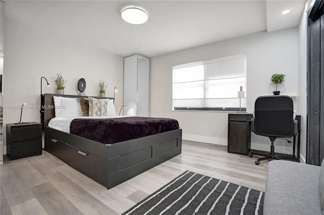 bedroom featuring recessed lighting, light wood-style flooring, and baseboards