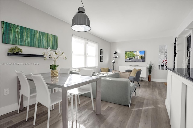 dining area with baseboards and light wood-type flooring