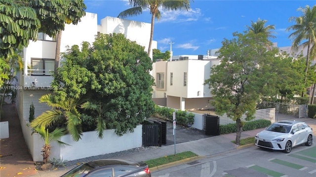 view of property featuring central AC and a fenced front yard