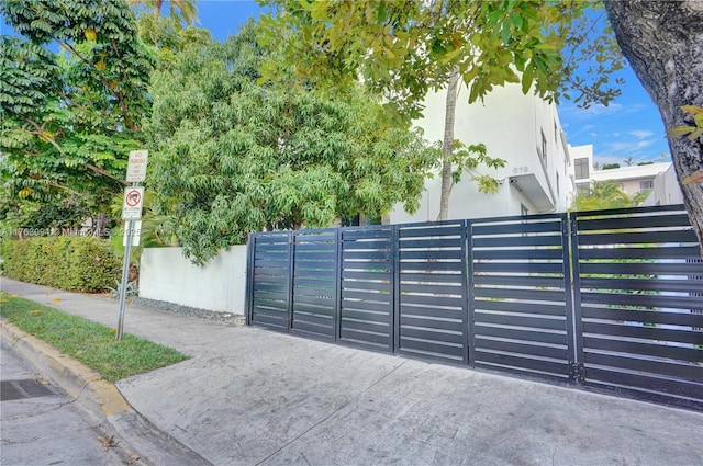 view of gate with a fenced front yard