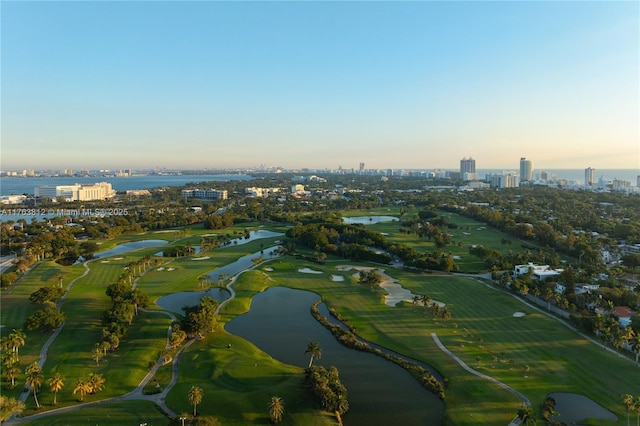 birds eye view of property with a city view, view of golf course, and a water view