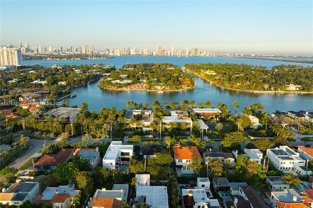 birds eye view of property with a view of city and a water view