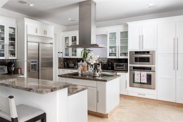 kitchen featuring decorative backsplash, island range hood, a center island, and stainless steel appliances