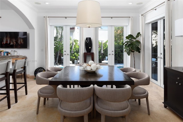 dining room with crown molding, plenty of natural light, and french doors