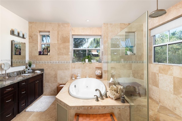 full bath featuring a tile shower, plenty of natural light, tile walls, and a whirlpool tub