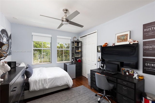 bedroom with dark wood finished floors, a closet, and ceiling fan