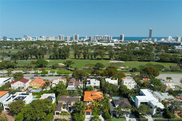 aerial view featuring view of golf course and a city view