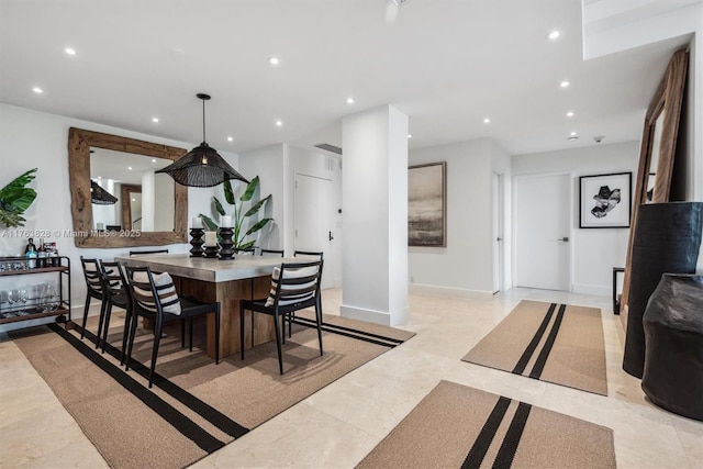 dining space featuring recessed lighting and baseboards