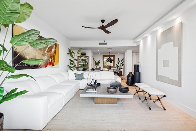 living room with visible vents and ceiling fan