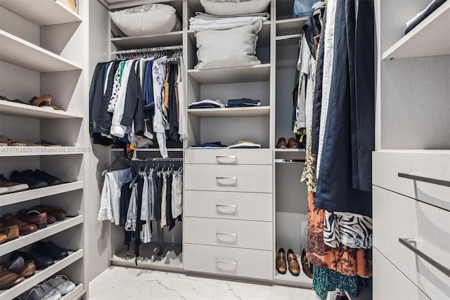 spacious closet with marble finish floor