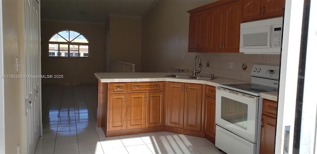 kitchen featuring crown molding, tile countertops, a peninsula, white appliances, and a sink