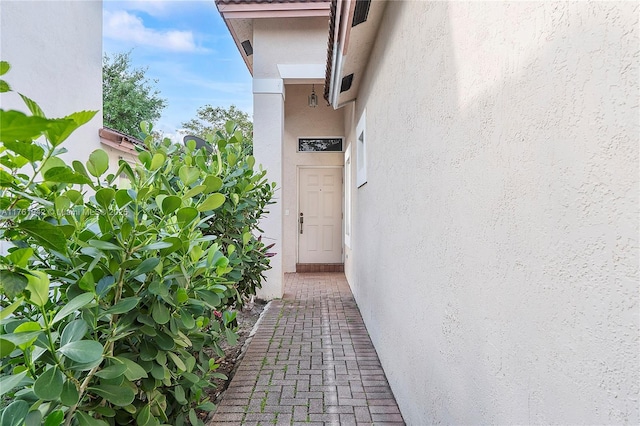 entrance to property with stucco siding