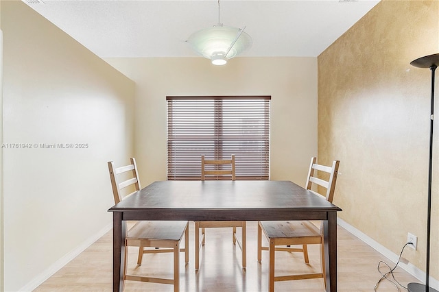 dining room with light wood finished floors and baseboards