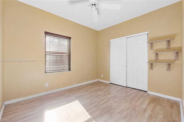 unfurnished bedroom with light wood-type flooring, baseboards, and a closet