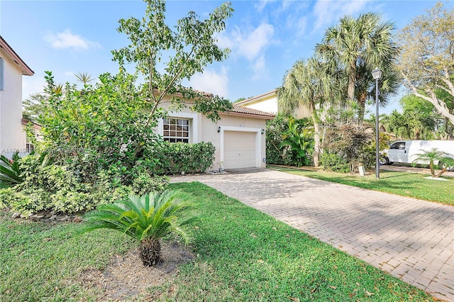 6244 NW 38th Dr, Coral Springs, FL 33067 - mediterranean / spanish-style house with decorative driveway, a garage, stucco siding, a front lawn, and a tile roof