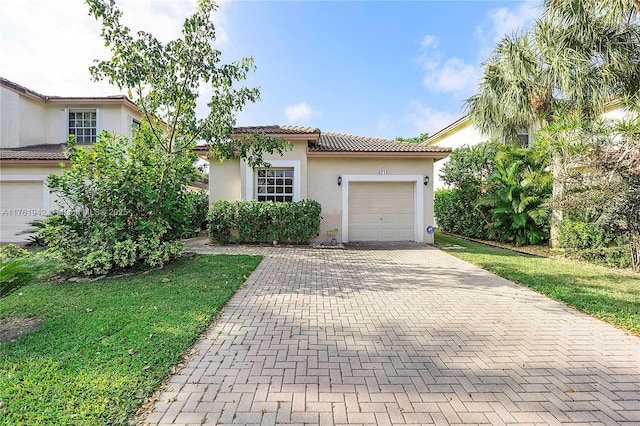 6244 NW 38th Dr, Coral Springs, FL 33067 - mediterranean / spanish-style house featuring stucco siding, decorative driveway, a garage, a tile roof, and a front yard