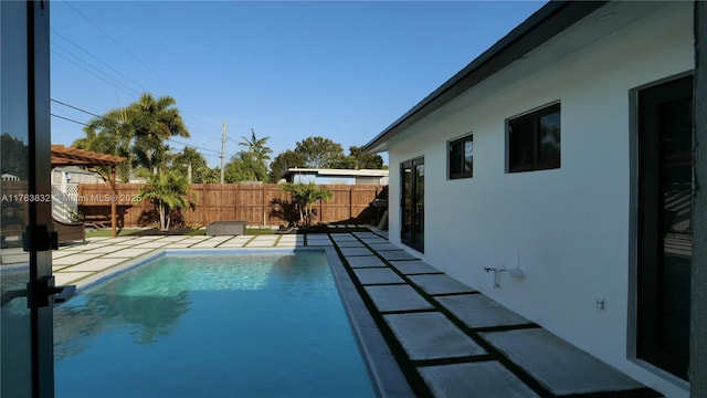 view of swimming pool featuring a fenced in pool, a patio, and a fenced backyard