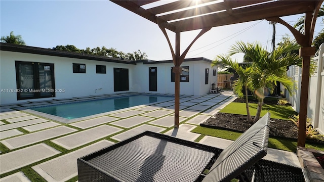 pool with a fenced backyard, a pergola, and a patio area