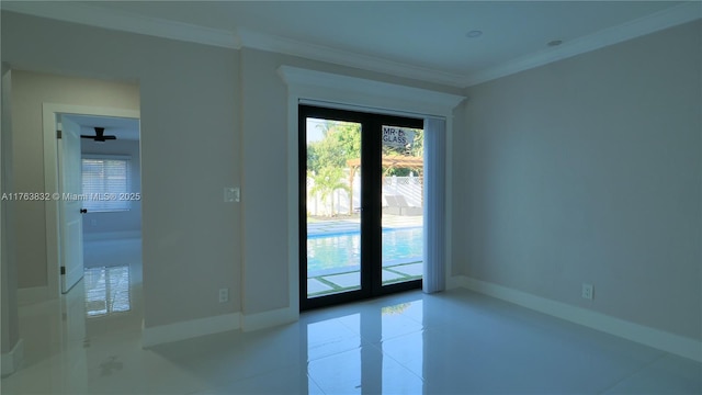 tiled spare room featuring baseboards and crown molding