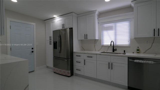 kitchen with a sink, dishwashing machine, white cabinets, and stainless steel refrigerator with ice dispenser