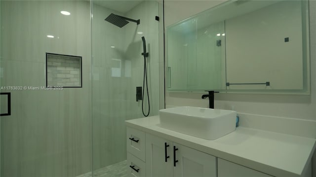 full bath with a stall shower and vanity