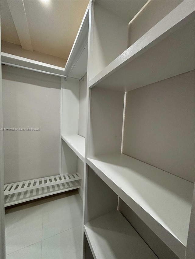 spacious closet featuring tile patterned floors