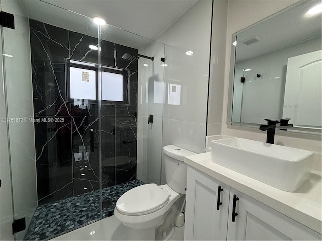 bathroom featuring a marble finish shower, visible vents, and toilet