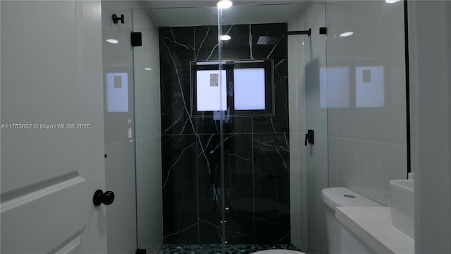 bathroom with a marble finish shower, toilet, and vanity