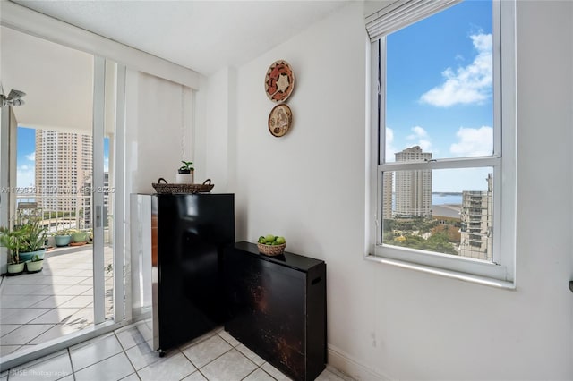 room details featuring fridge, black refrigerator, and a city view