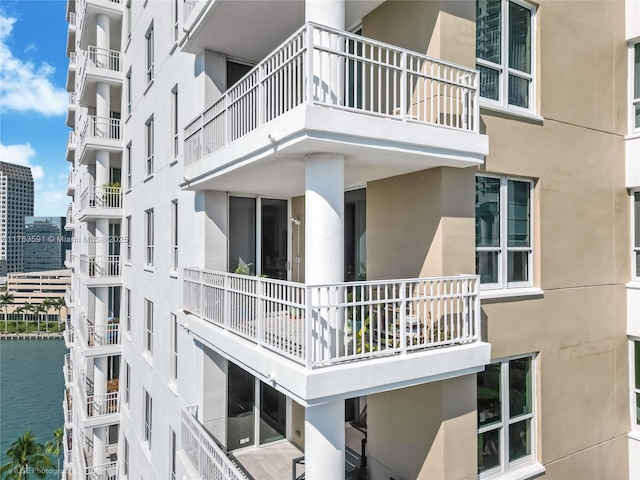 view of building exterior with a view of city and a water view