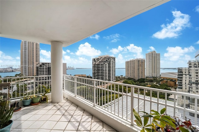 balcony with a view of city and a water view