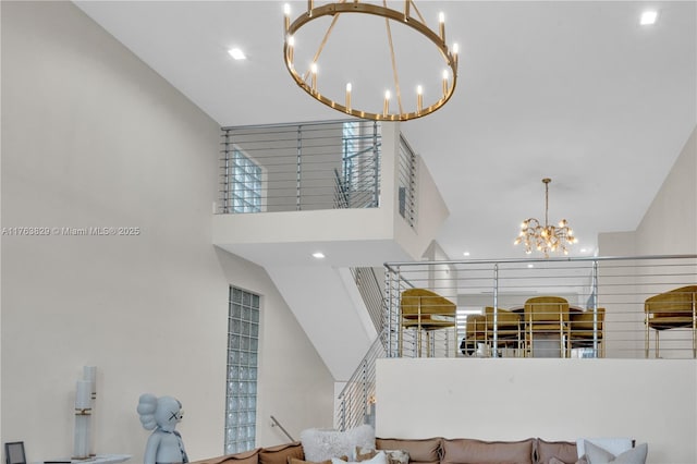 stairs with a chandelier and a towering ceiling