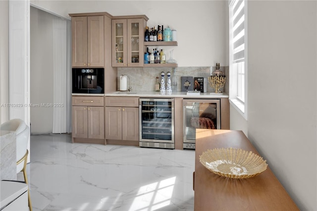 bar with beverage cooler, marble finish floor, bar, and a sink