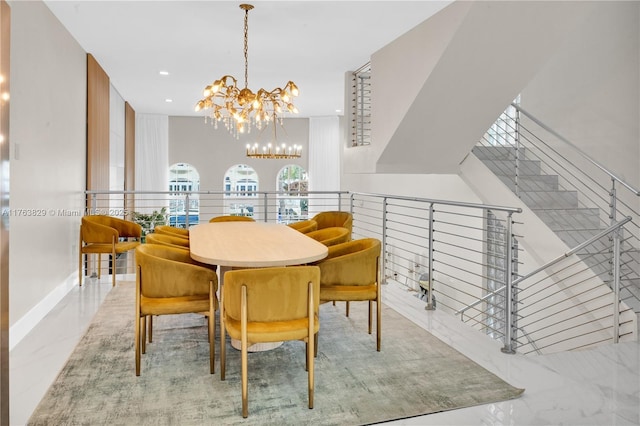 dining space featuring recessed lighting, marble finish floor, and a chandelier