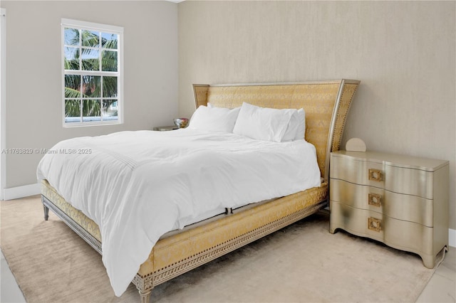 bedroom featuring baseboards and carpet