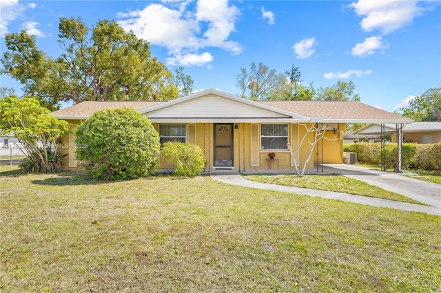 single story home with cooling unit, a carport, concrete driveway, and a front yard