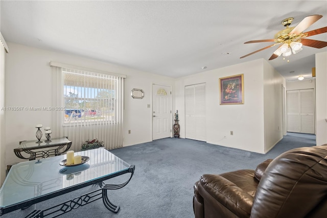 living room featuring a ceiling fan and carpet floors