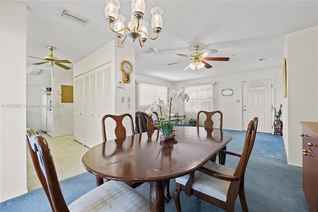 dining area featuring visible vents, ceiling fan with notable chandelier, and carpet flooring