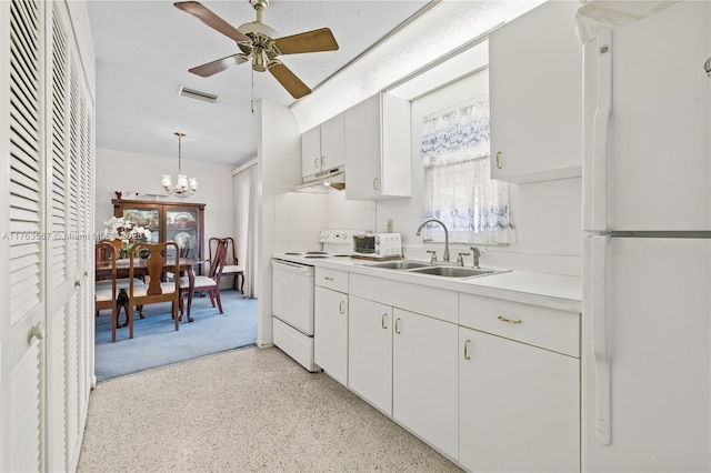 kitchen featuring white appliances, visible vents, a sink, light countertops, and ceiling fan with notable chandelier