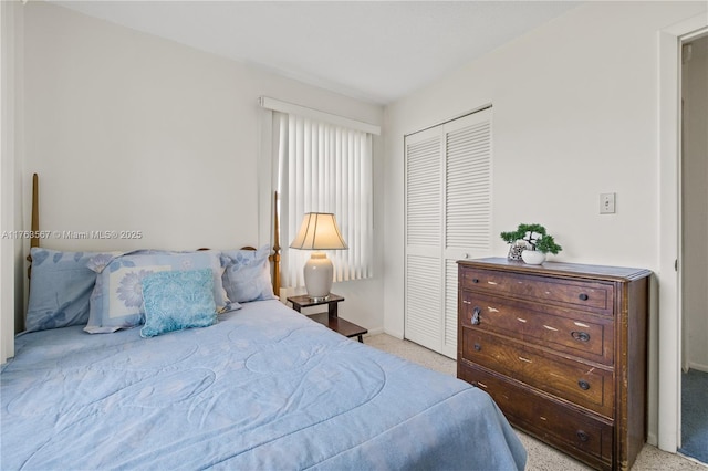 bedroom with a closet and light carpet