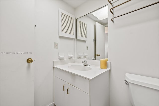 bathroom with toilet and vanity