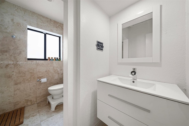 bathroom featuring toilet, vanity, and tile patterned flooring