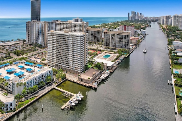 birds eye view of property featuring a city view and a water view